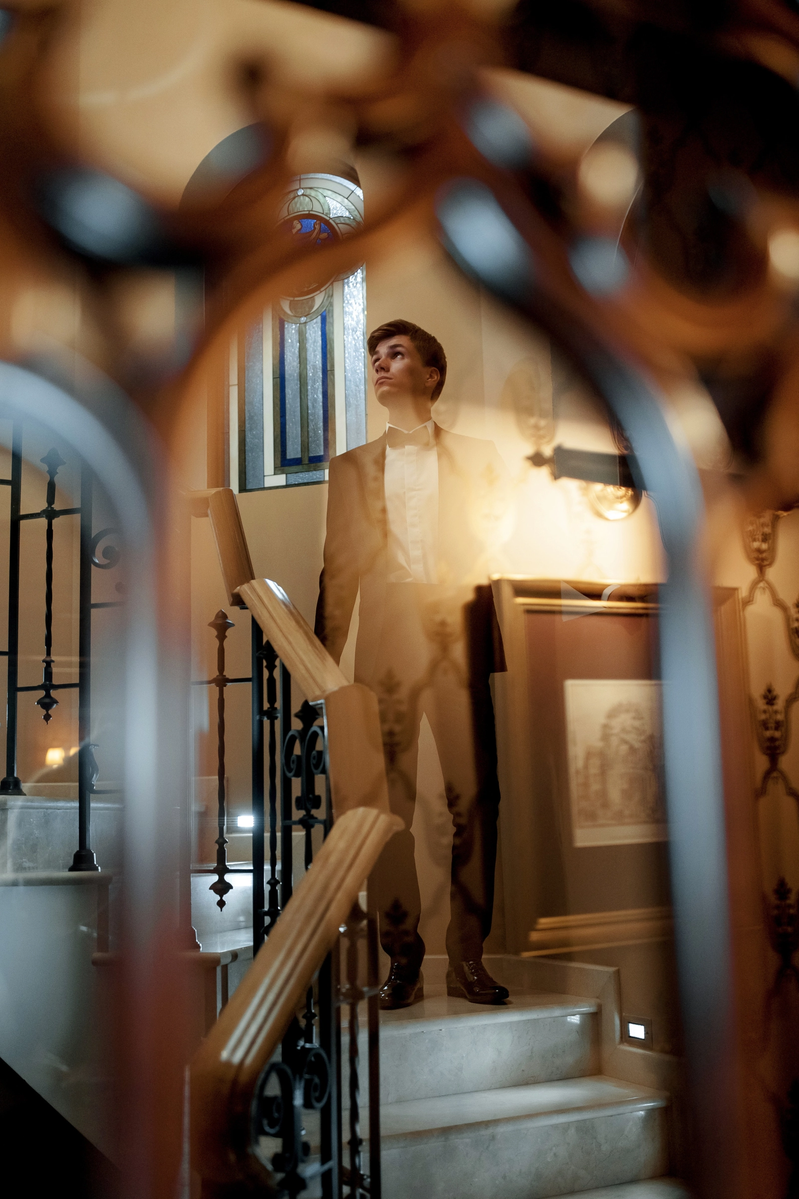 Groom formal suit crystal bokeh romantic interior portrait