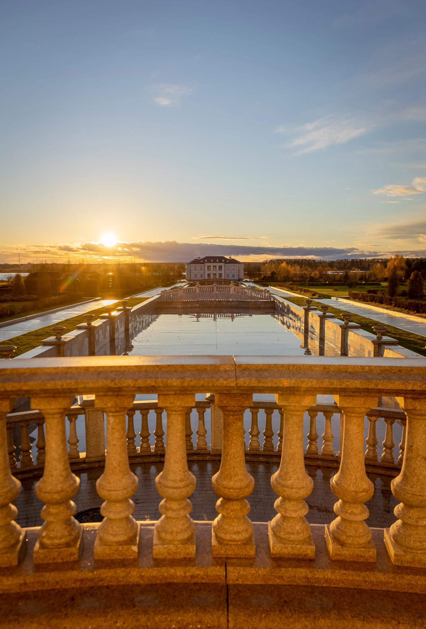Estate sunset view classical terrace ornate balustrade pond reflection