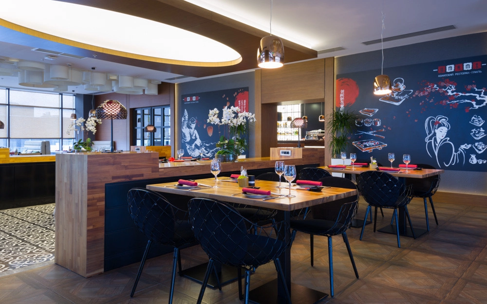 Modern banquet room with blue wall art and geometric ceiling feature
