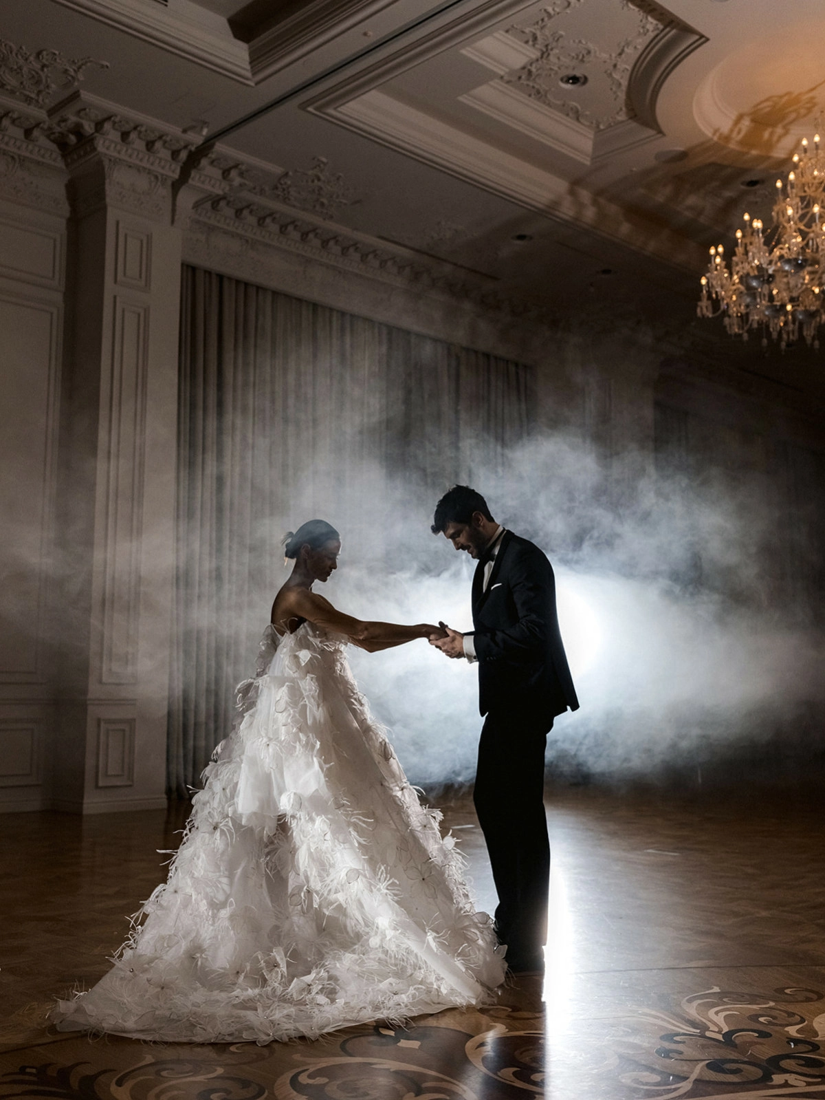 Couple ballroom bride feathered gown groom smoke venue