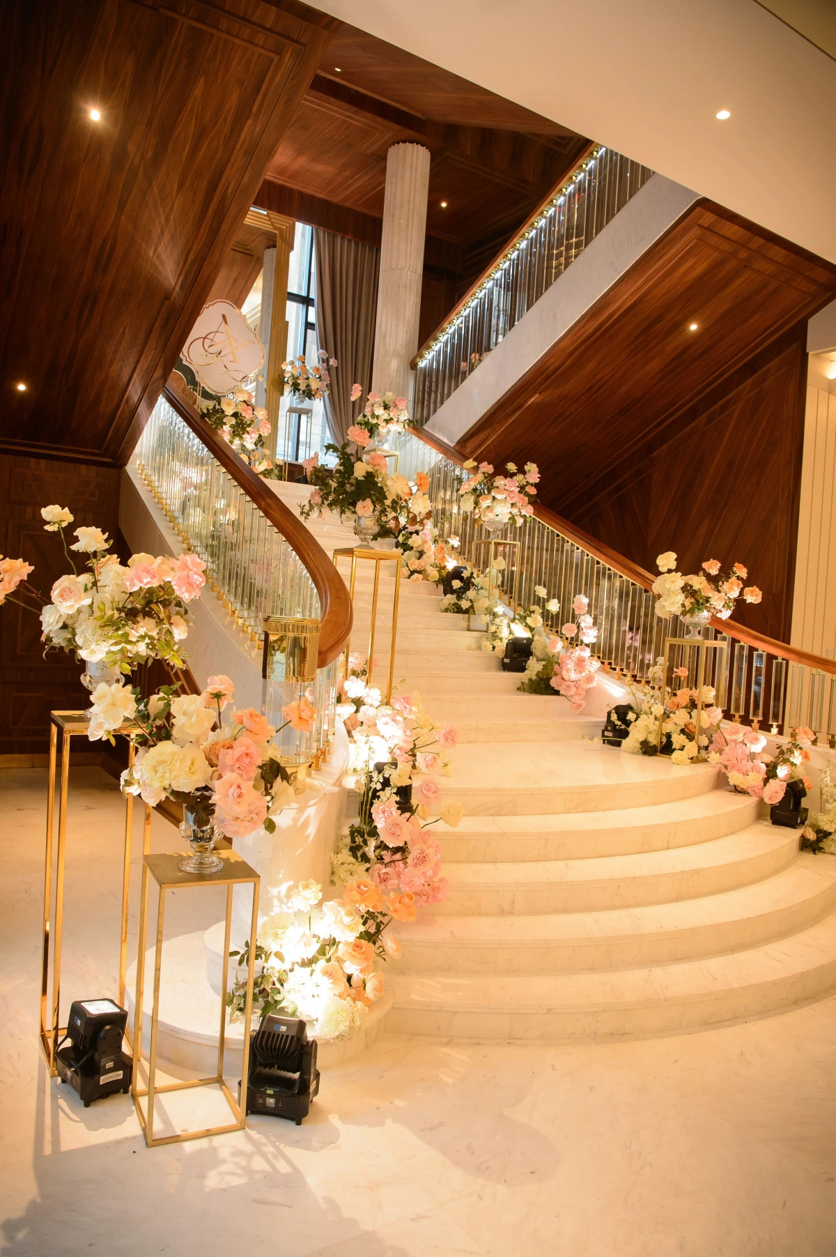 Decorated wedding staircase with pink white flowers venue