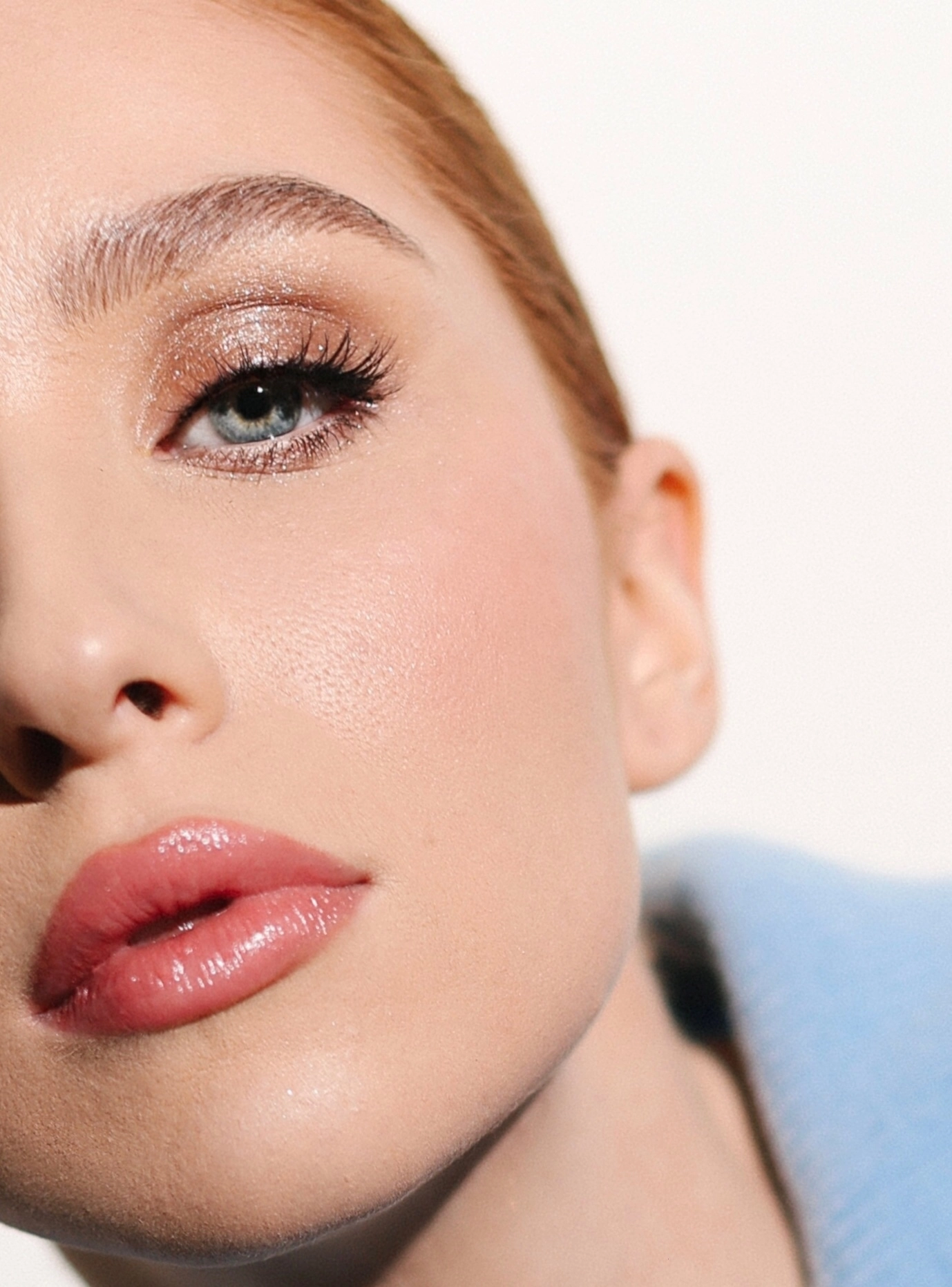 Shimmer eyeshadow with coral-pink lip bridal makeup studio portrait