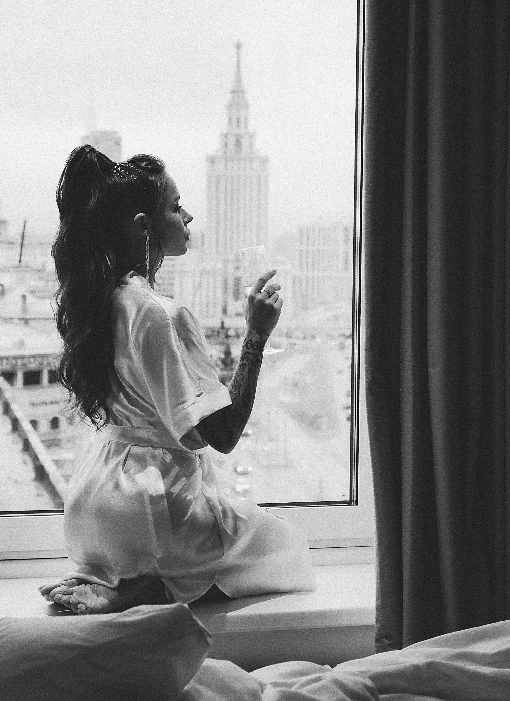 Bride white robe window cityscape morning getting-ready