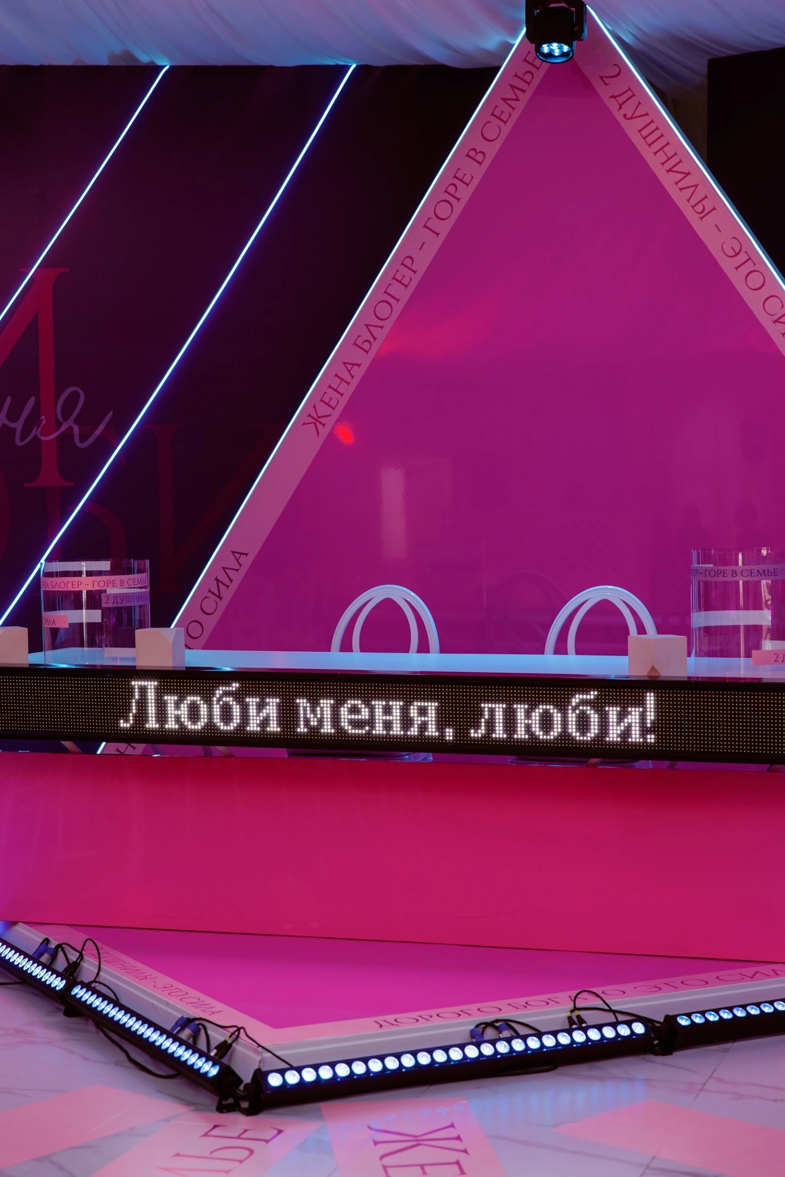 президентский стол с неоновой треугольной аркой и розовой подсветкой на банкете