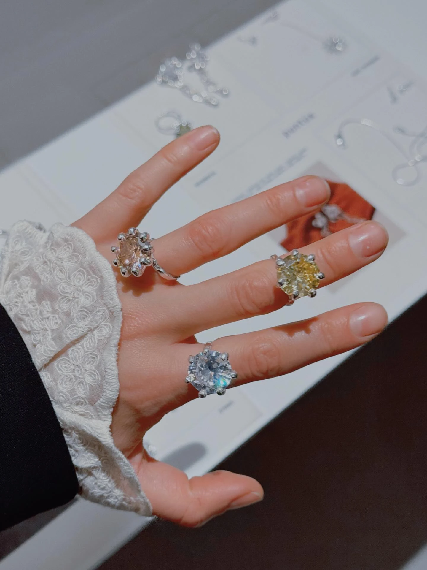 серебряные кольца с розовым жёлтым и голубым камнями на пальцах руки
